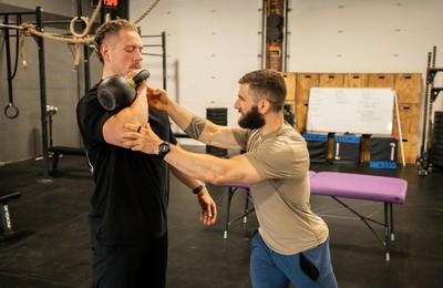 physical-therapist-correcting-an-exercise